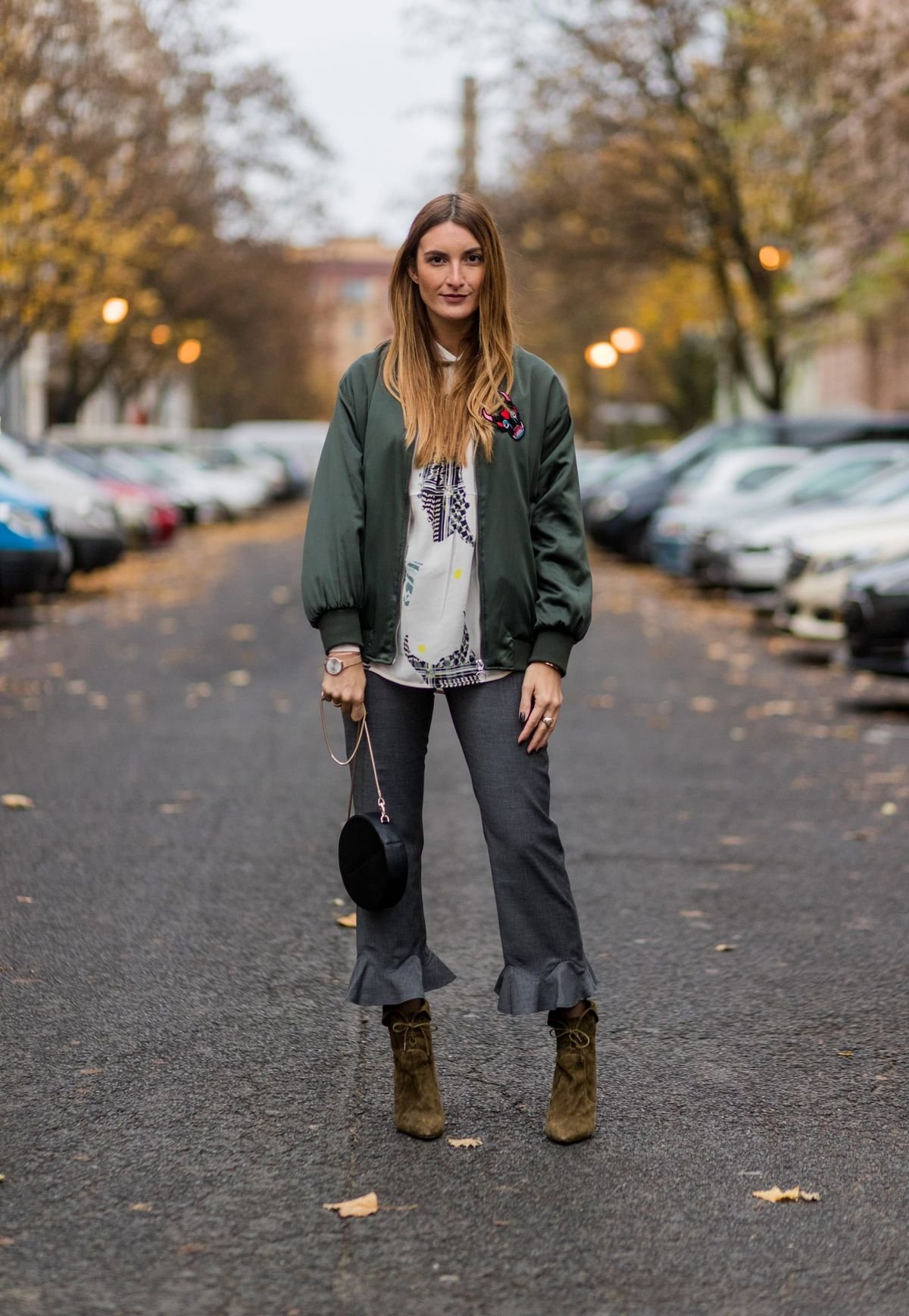 Woman wearing a date night bomber jacket outfit outdoors in autumn