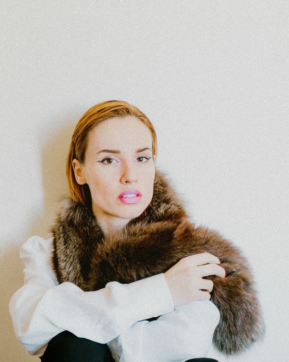 Portrait of a woman wearing a white blouse and fur scarf