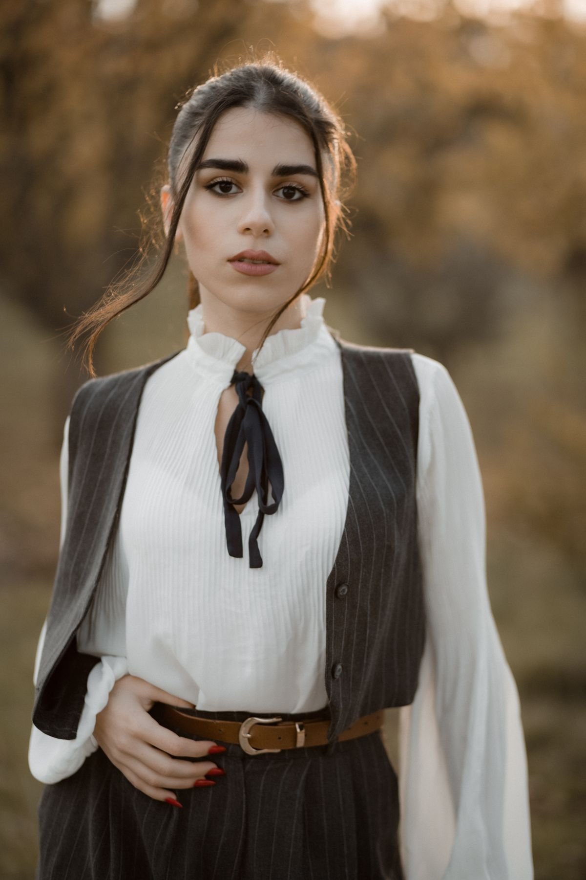 Woman wearing a tailored pinstripe waistcoat gilet over a white blouse