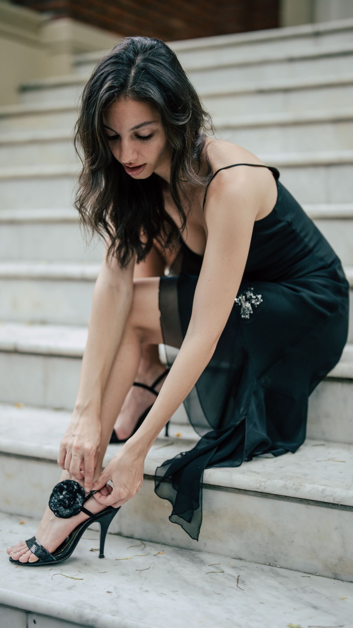Woman adjusting elegant kitten heels before a wedding