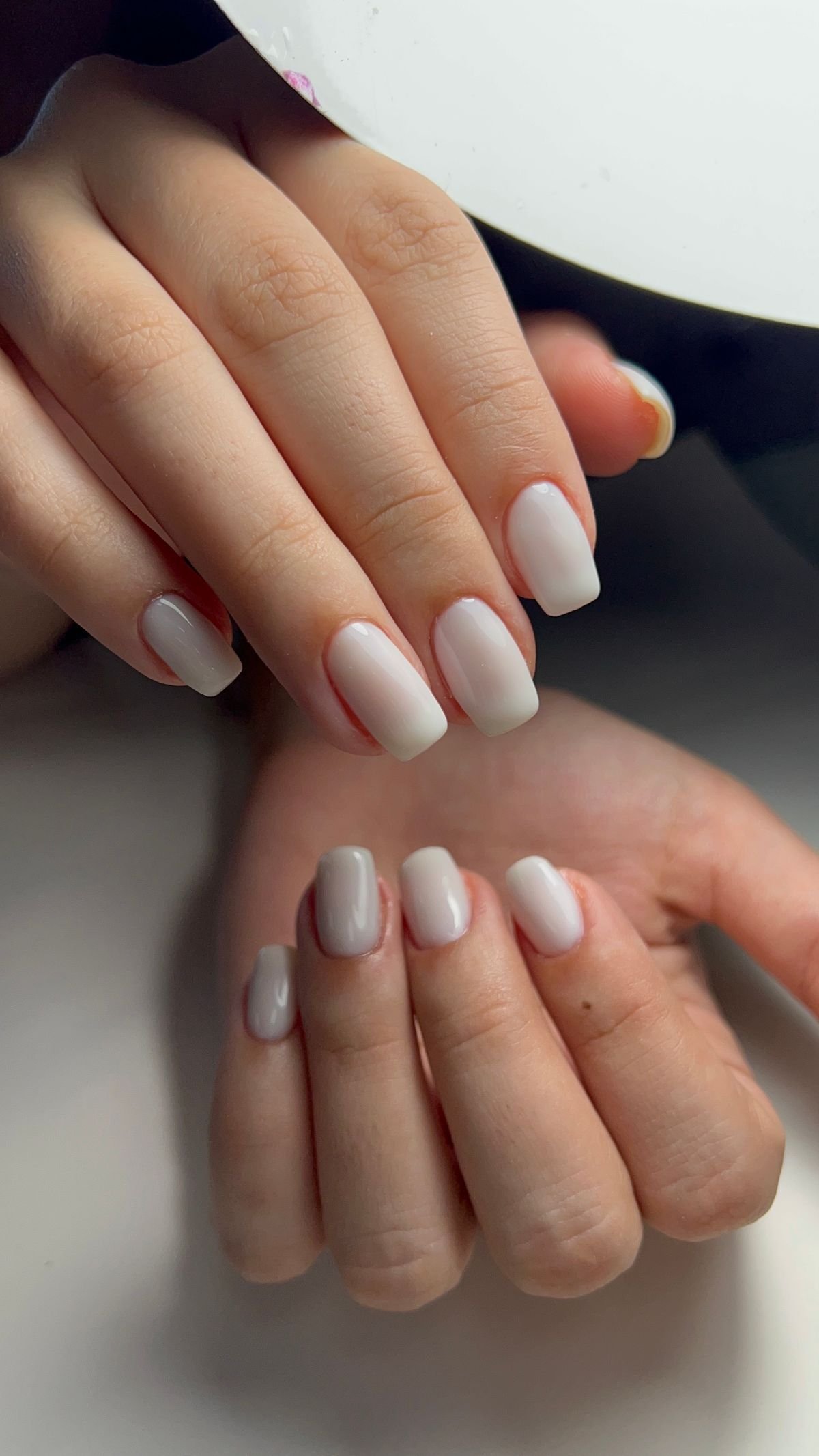 Hands with a sheer nude naked nail manicure