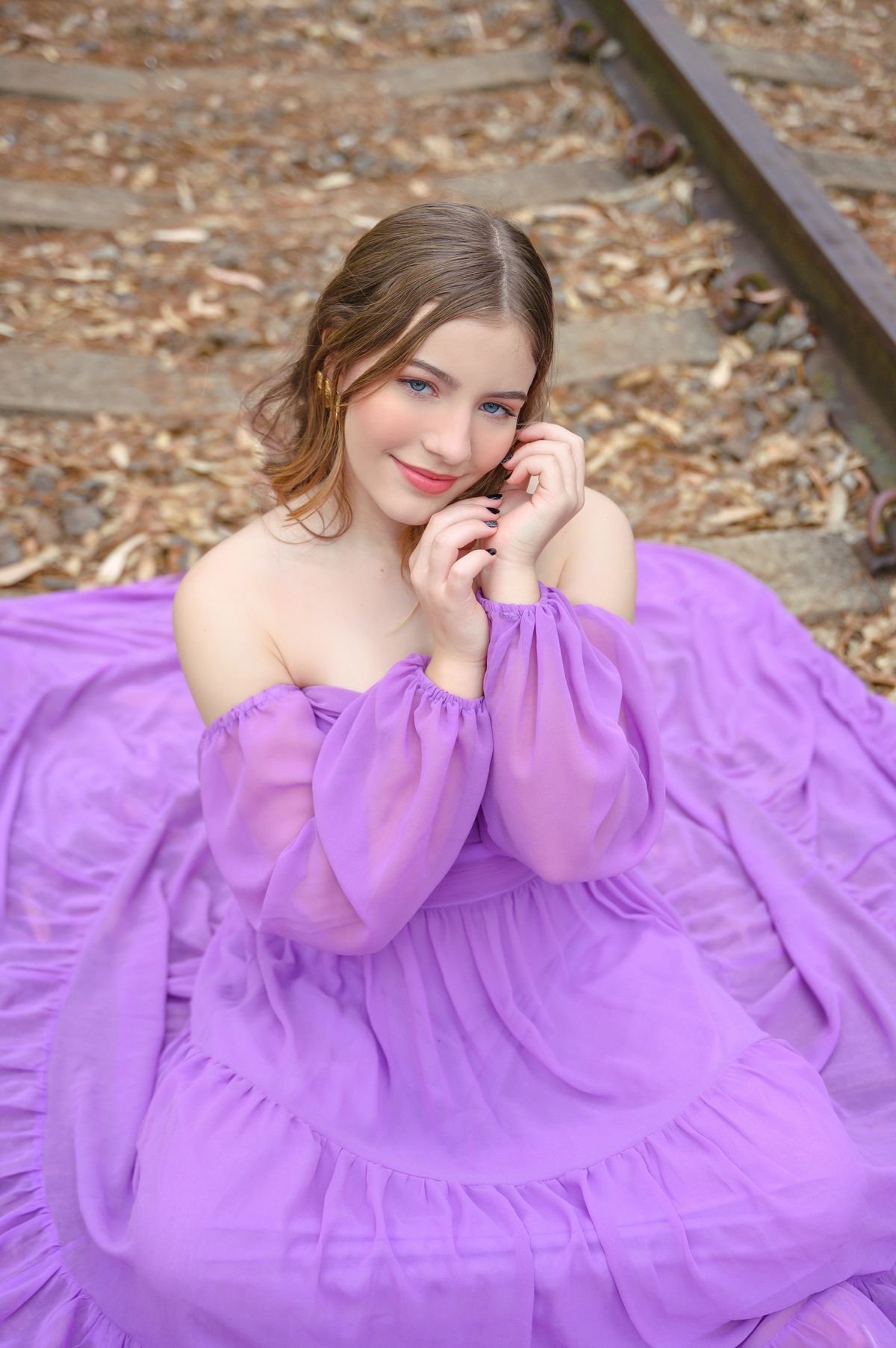 Woman wearing a rich royal purple outfit outdoors in autumn