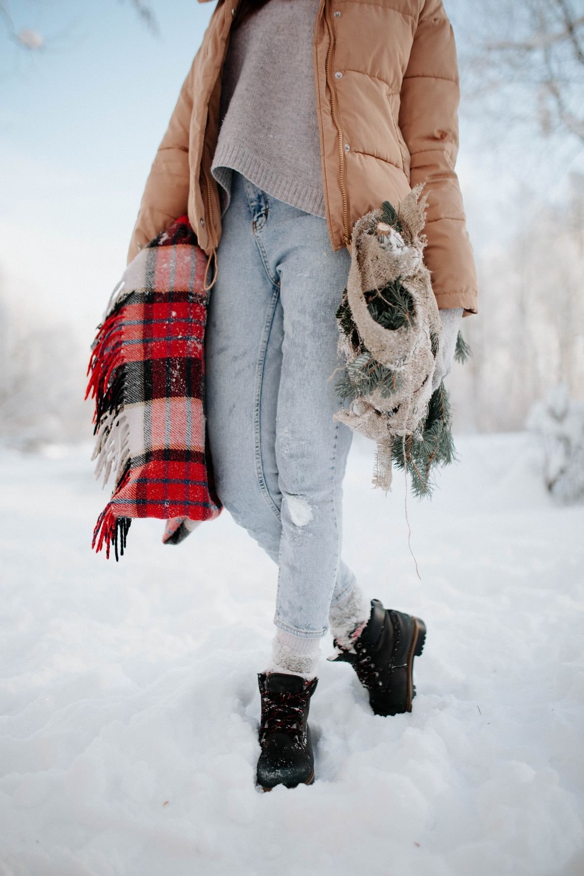 Woman wearing UGG mini boots with straight jeans and a knit sweater