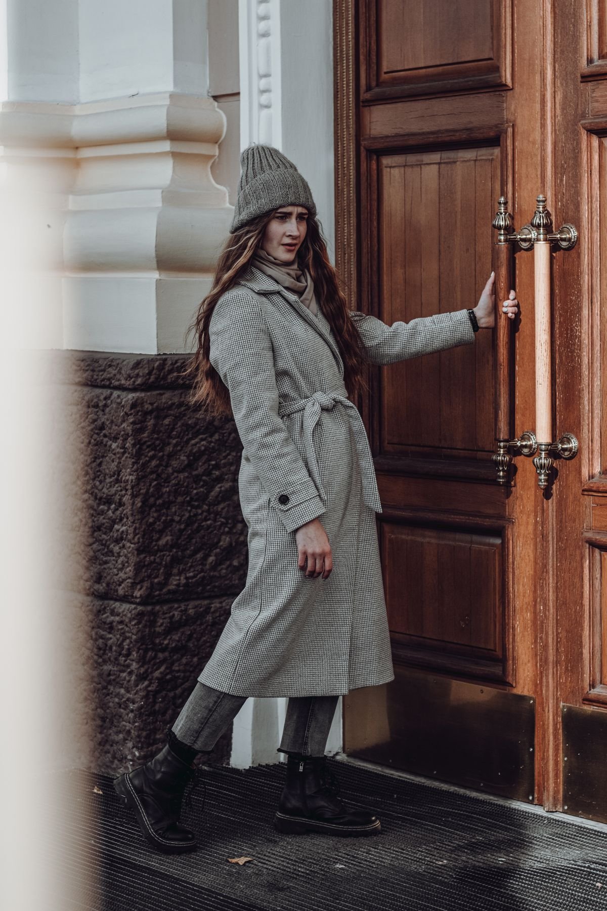 Woman in UGG boots with a long wool coat and straight jeans