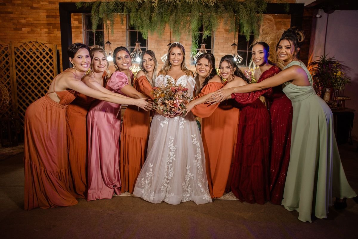 Bride standing with her bridesmaids in elegant dresses